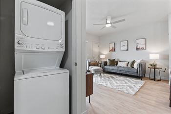 A white washing machine is in a laundry room.